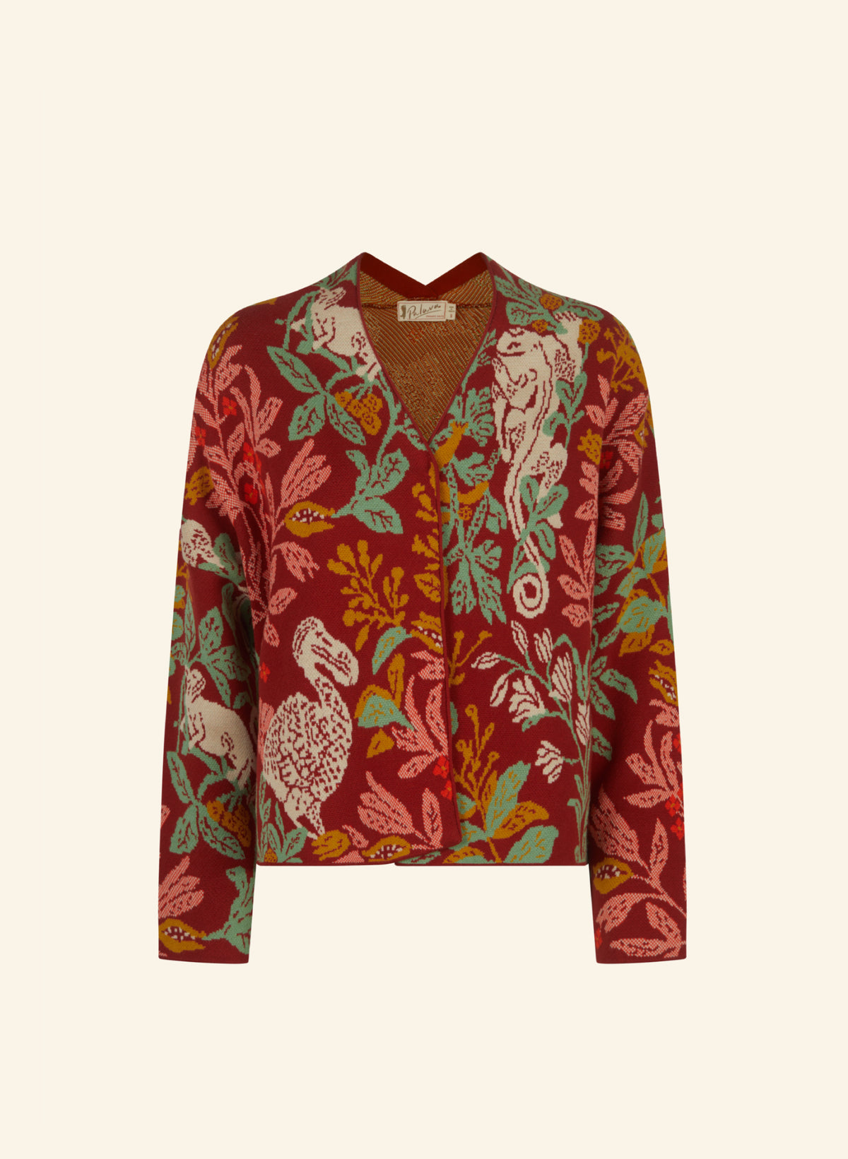 A long-sleeve button-front kimono-inspired cardigan featuring a rich botanical and animal print in deep red, sage green, mustard yellow, and cream, displayed on a solid off-white background.