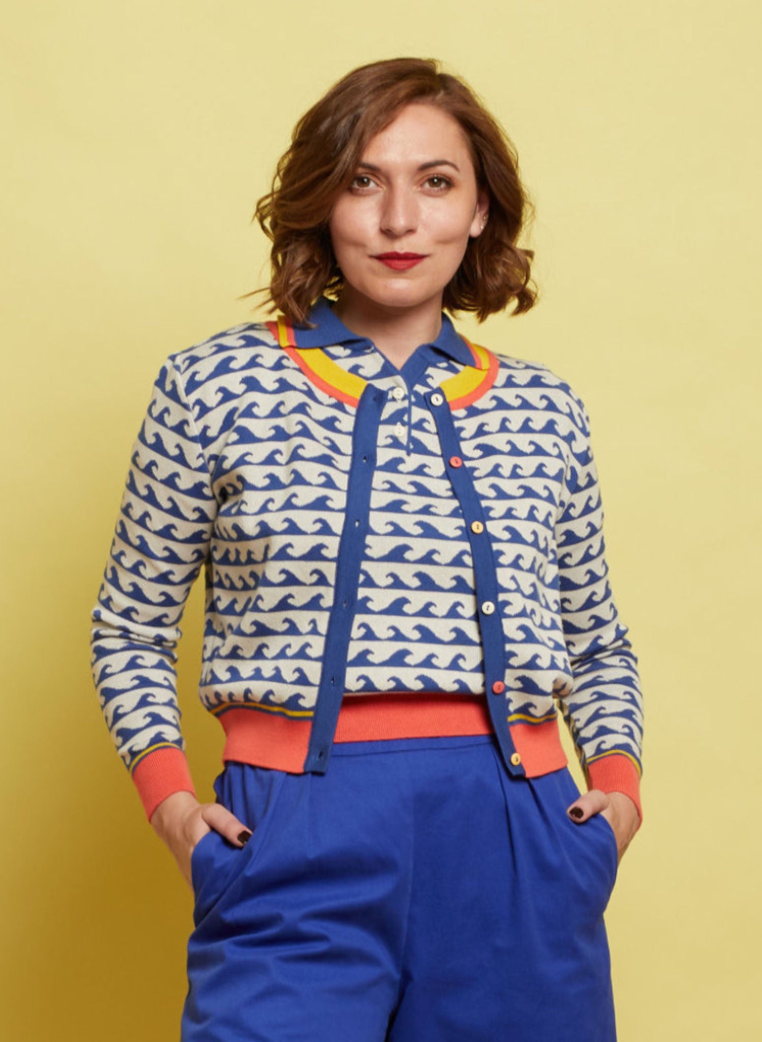 Women's knitted cotton cardigan by Palava in blue wave pattern on white with yellow and coral trims