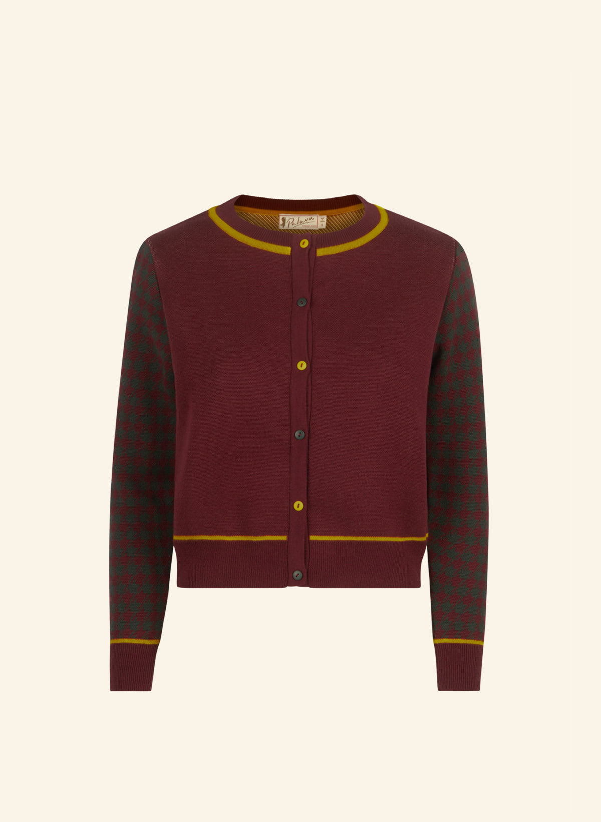 A cropped burgundy cardigan sweater with a solid burgundy body, yellow ribbed trim, and patterned green and yellow sleeves, shown against a light cream background.