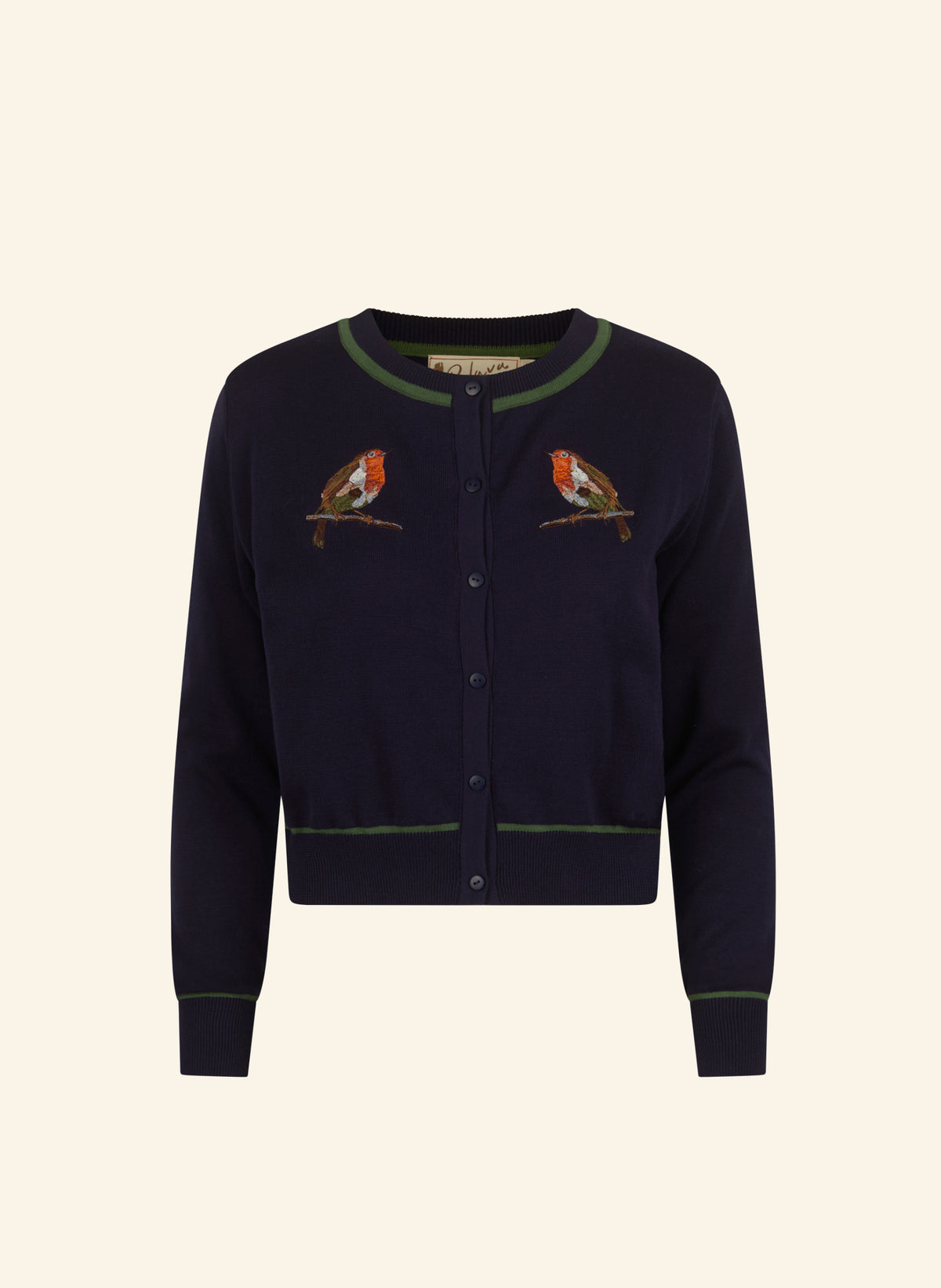 A navy blue cropped cardigan sweater featuring green trim and embroidered birds on the chest, displayed against a solid cream background.