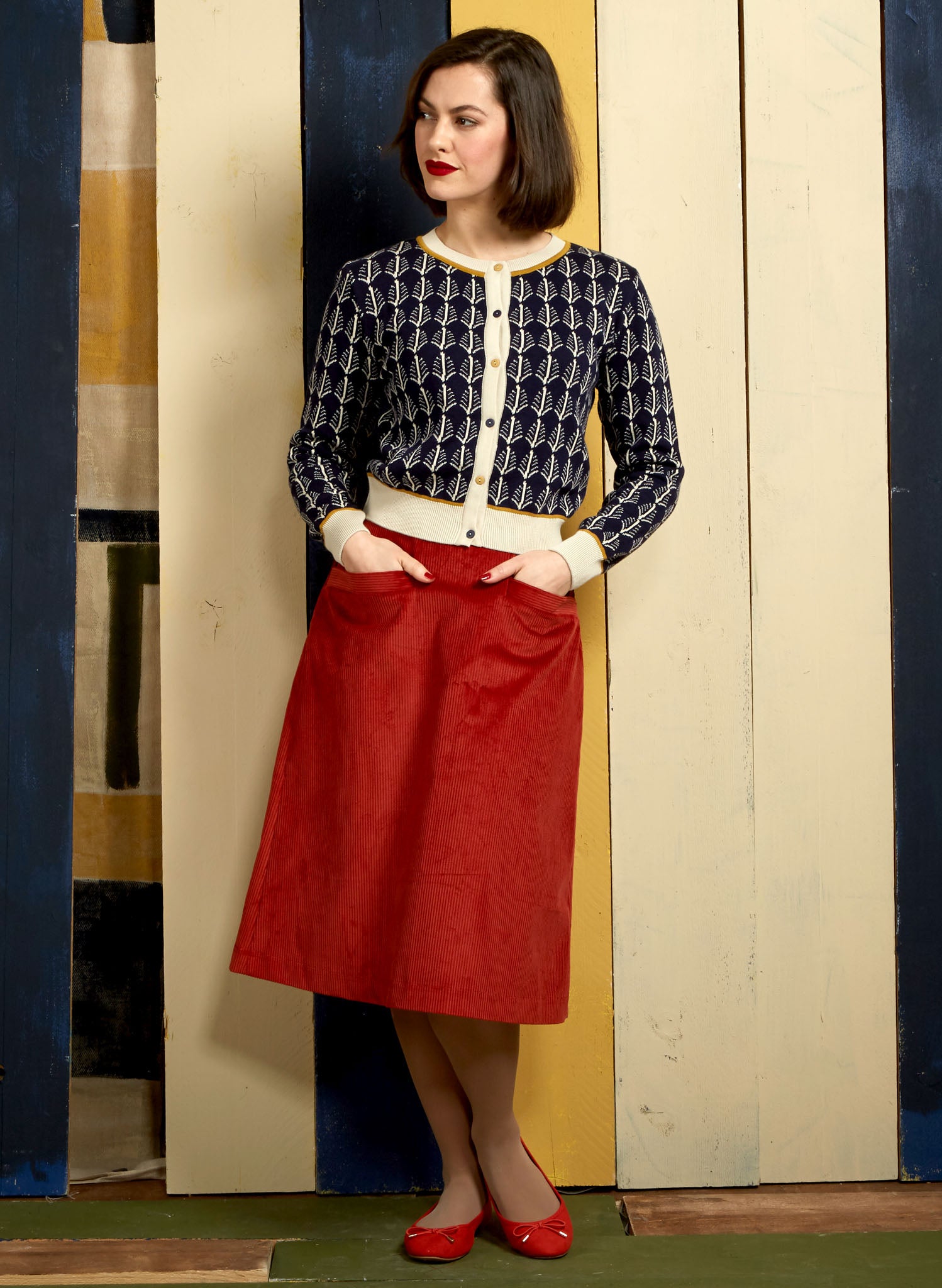 vintage style organic cotton navy cardigan with feathers print and orange corduroy organic cotton pencil skirt