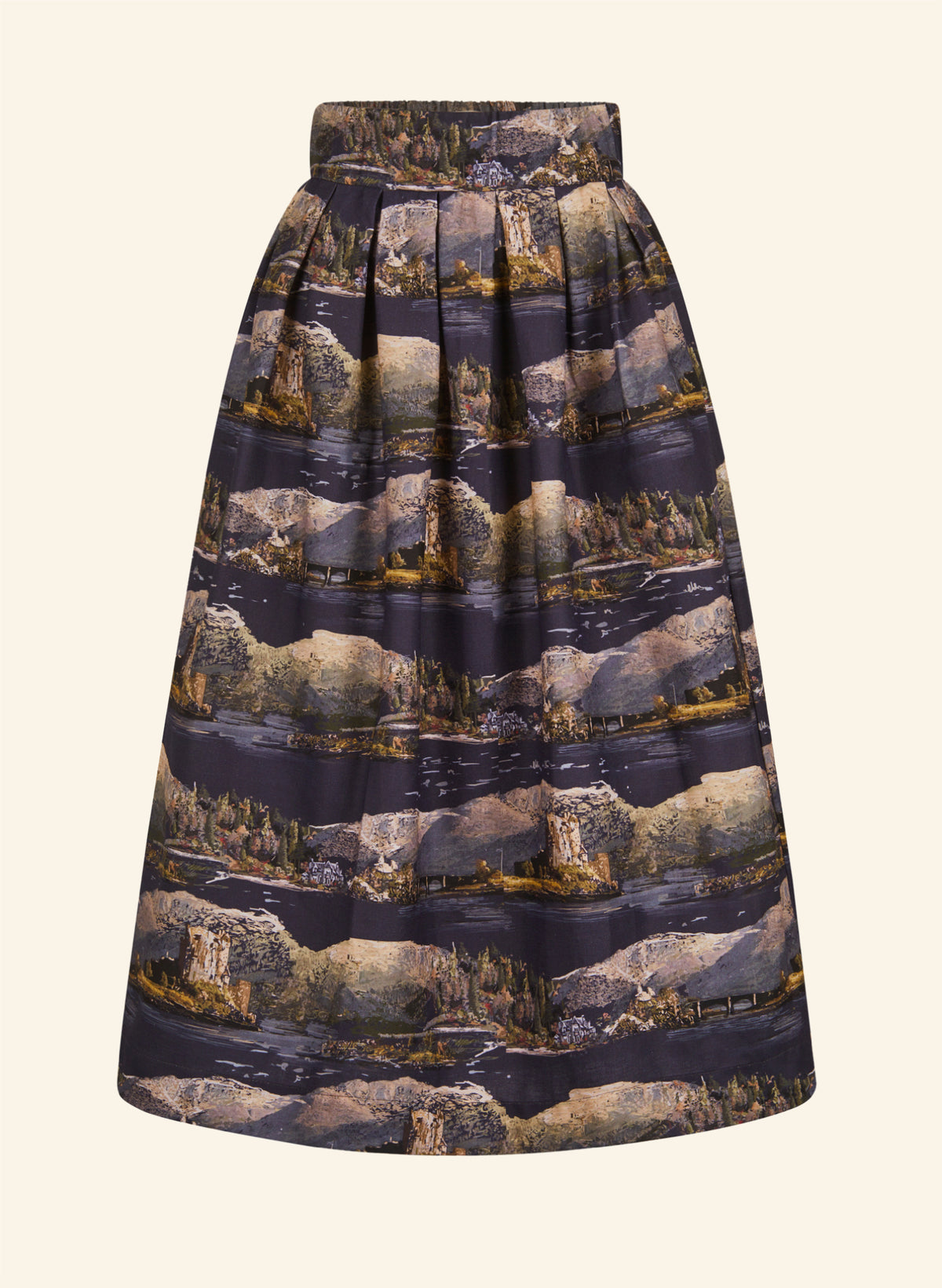 A pleated A-line skirt featuring an all-over scenic landscape print of mountains, lakes, and stone towers in muted earth tones and dark navy, shown against a solid cream background.
