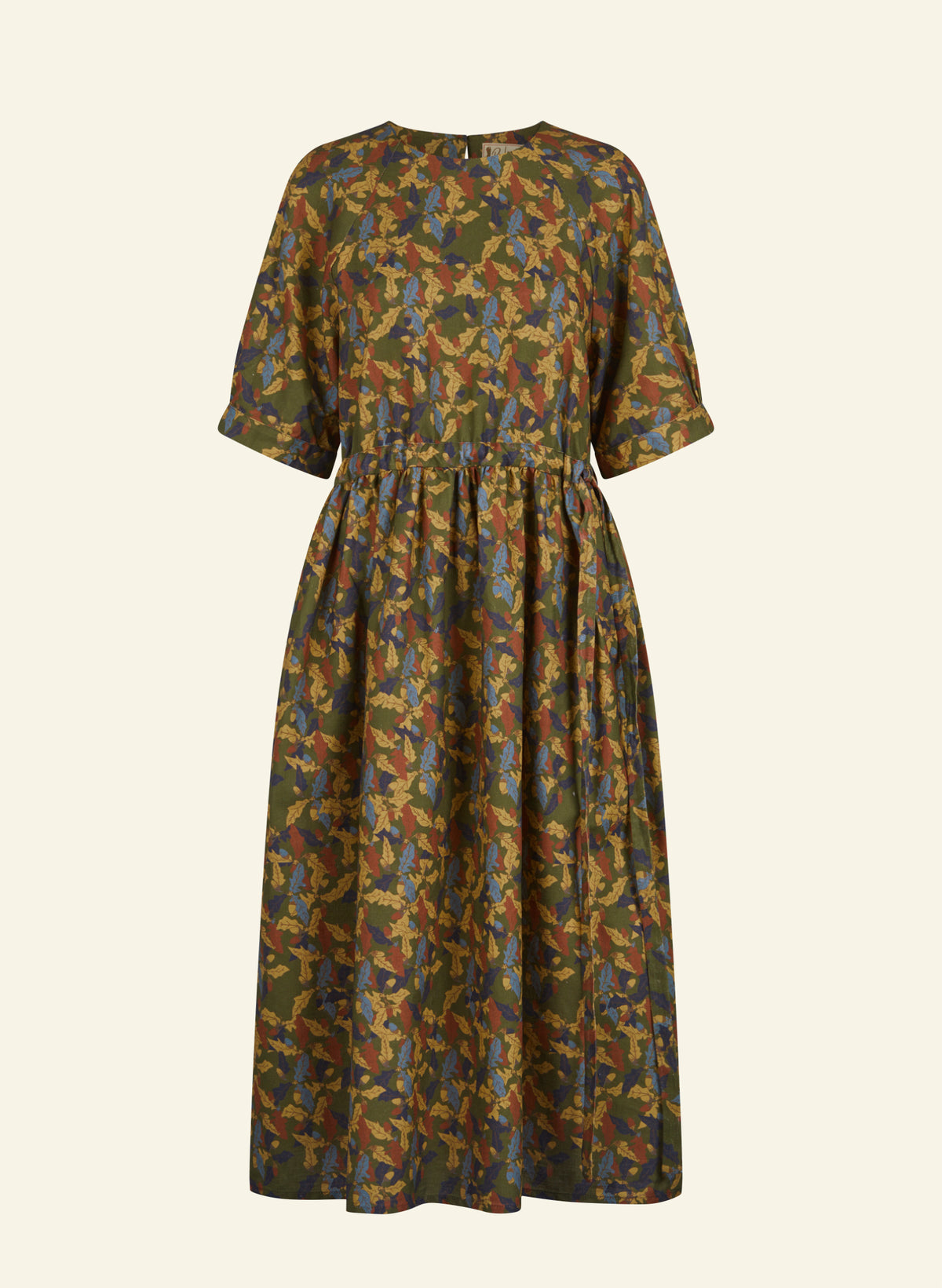 A short-sleeve midi dress with a gathered waist and an abstract camouflage-like print in olive green, mustard yellow, brown, and blue, shown against a solid off-white background.