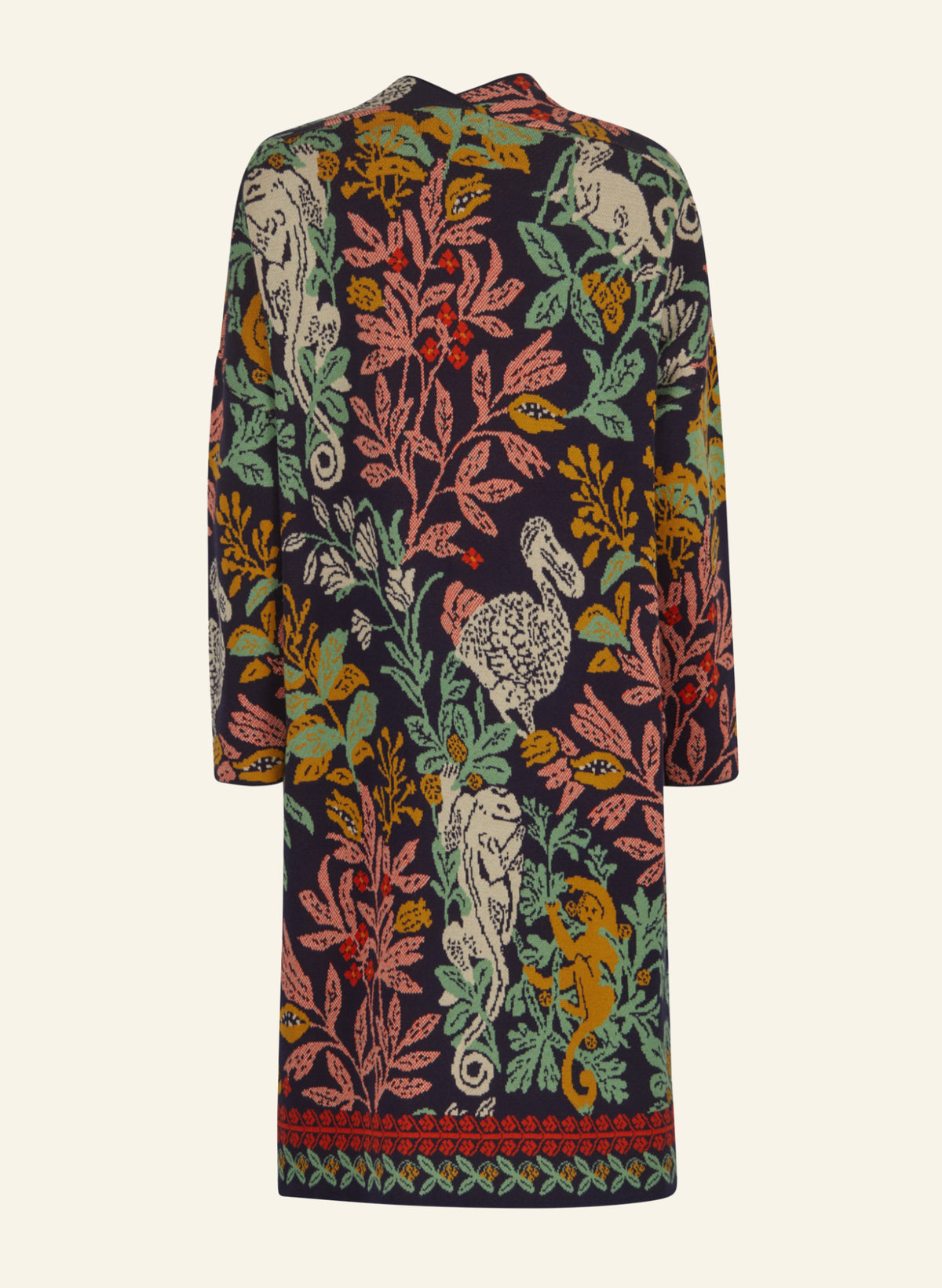 A long-sleeve knit coat featuring an intricate multicolor print of leopards, tigers, and foliage on a dark navy background, shown against a light cream backdrop.