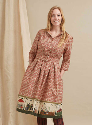 100% organic cotton midi-length belted shirt dress with 3/4 length sleeves in rust with a farmers market print