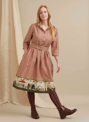 100% organic cotton midi-length belted shirt dress with 3/4 length sleeves in rust with a farmers market print