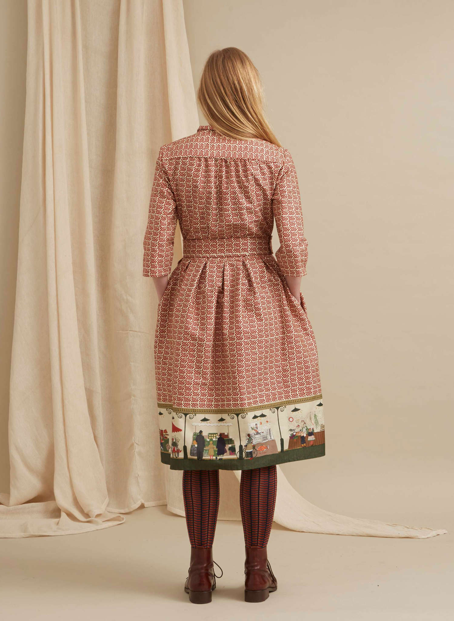 100% organic cotton midi-length belted shirt dress with 3/4 length sleeves in rust with a farmers market print