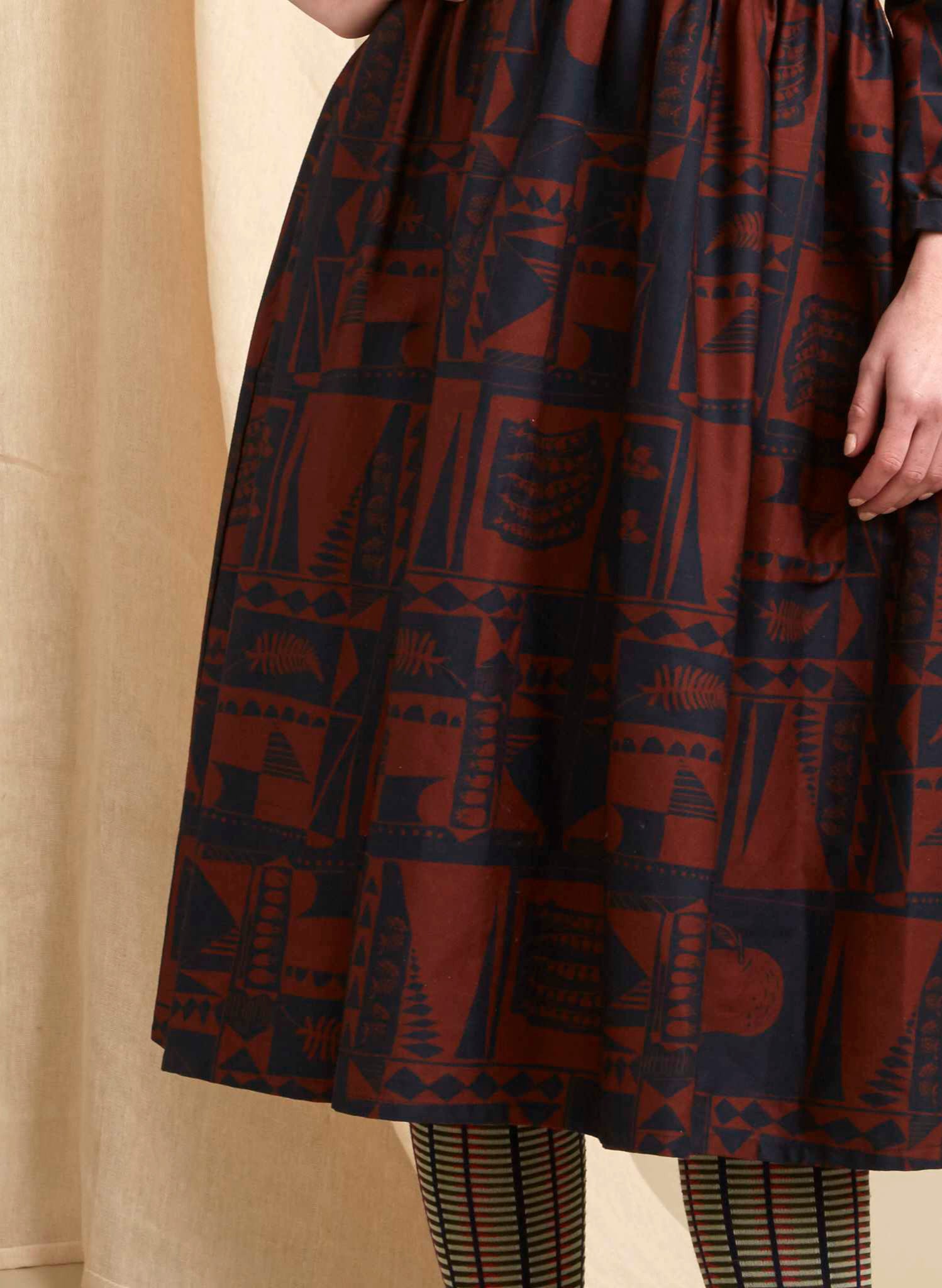 organic cotton navy and red 1940s-style knee-length dress with tie-waist belt and a greenhouse print