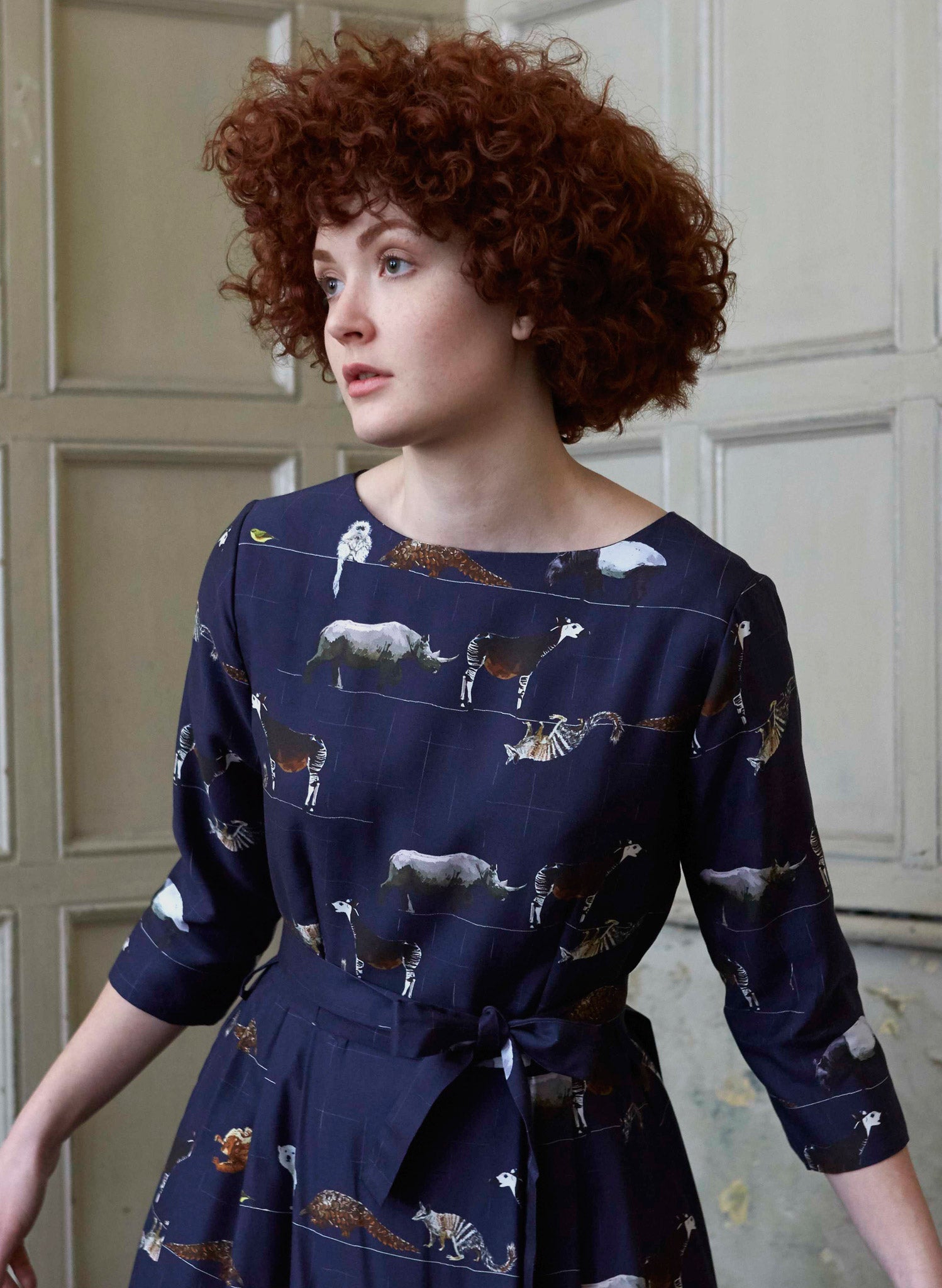 100% Tencel navy midi dress with tie-waist belt, 3/4 length sleeves, and endangered animals print