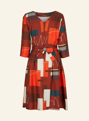 100% Tencel red, navy, and white knee-length dress with a tie-waist belt, 3/4 length sleeves, pockets, v-neck back, and abstract barbican print