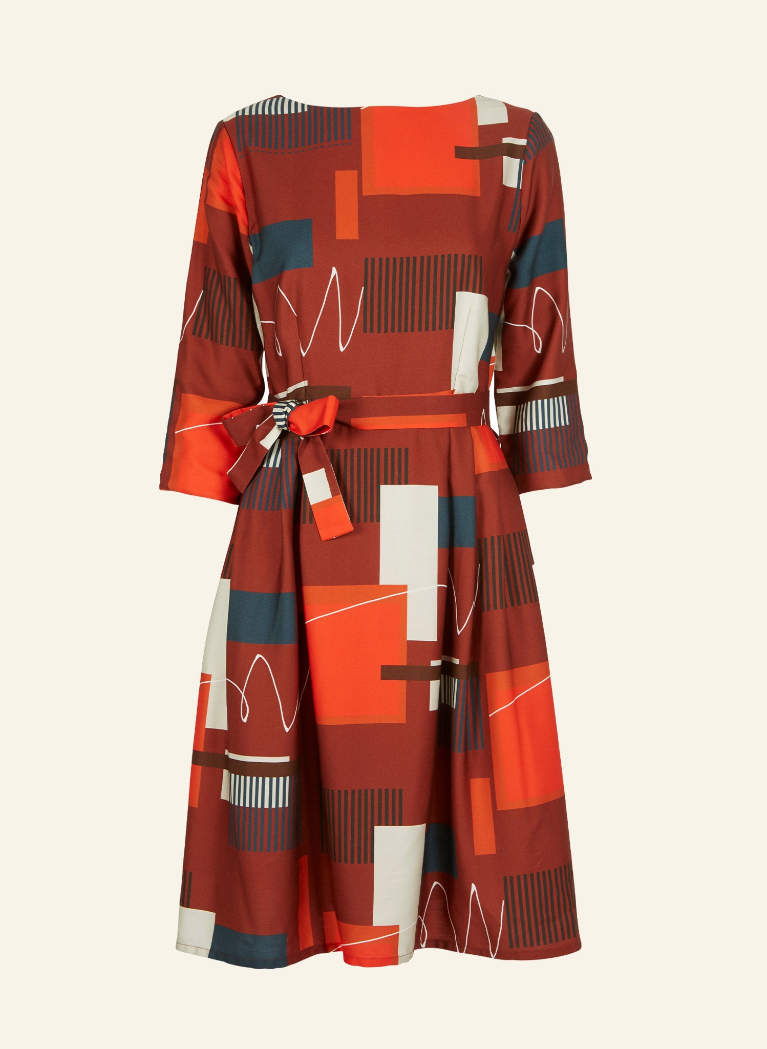 100% Tencel red, navy, and white knee-length dress with a tie-waist belt, 3/4 length sleeves, pockets, v-neck back, and abstract barbican print