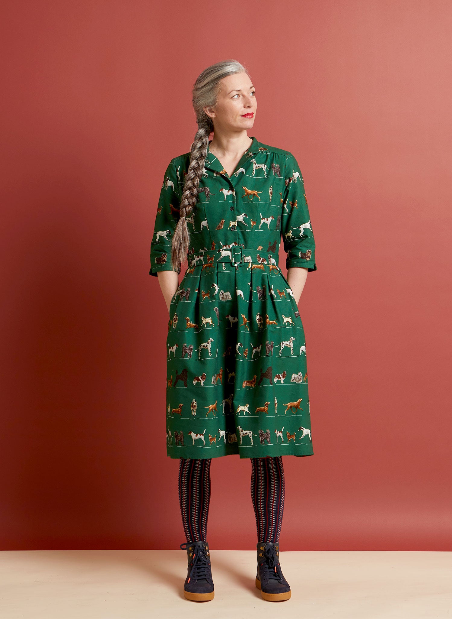 100% organic cotton vintage-style green knee-length belted shirt dress with 3/4 length sleeves, pockets, and green porcelain dogs print