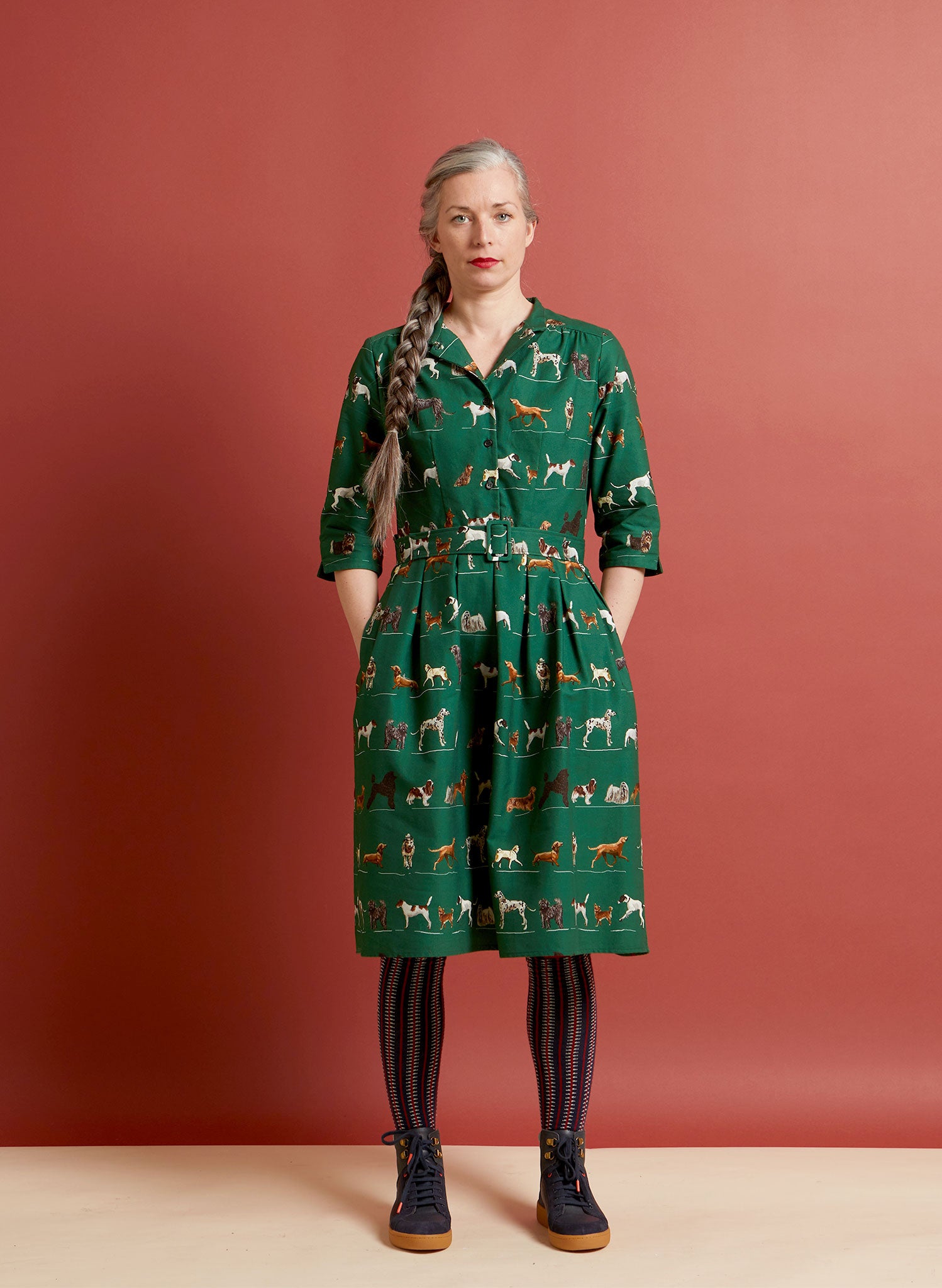 100% organic cotton vintage-style green knee-length belted shirt dress with 3/4 length sleeves, pockets, and green porcelain dogs print