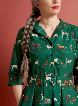 organic cotton vintage-style green knee-length belted shirt dress with 3/4 length sleeves, pockets, and green dogs print