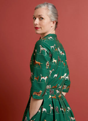 organic cotton vintage-style green knee-length belted shirt dress with 3/4 length sleeves, pockets, and green dogs print