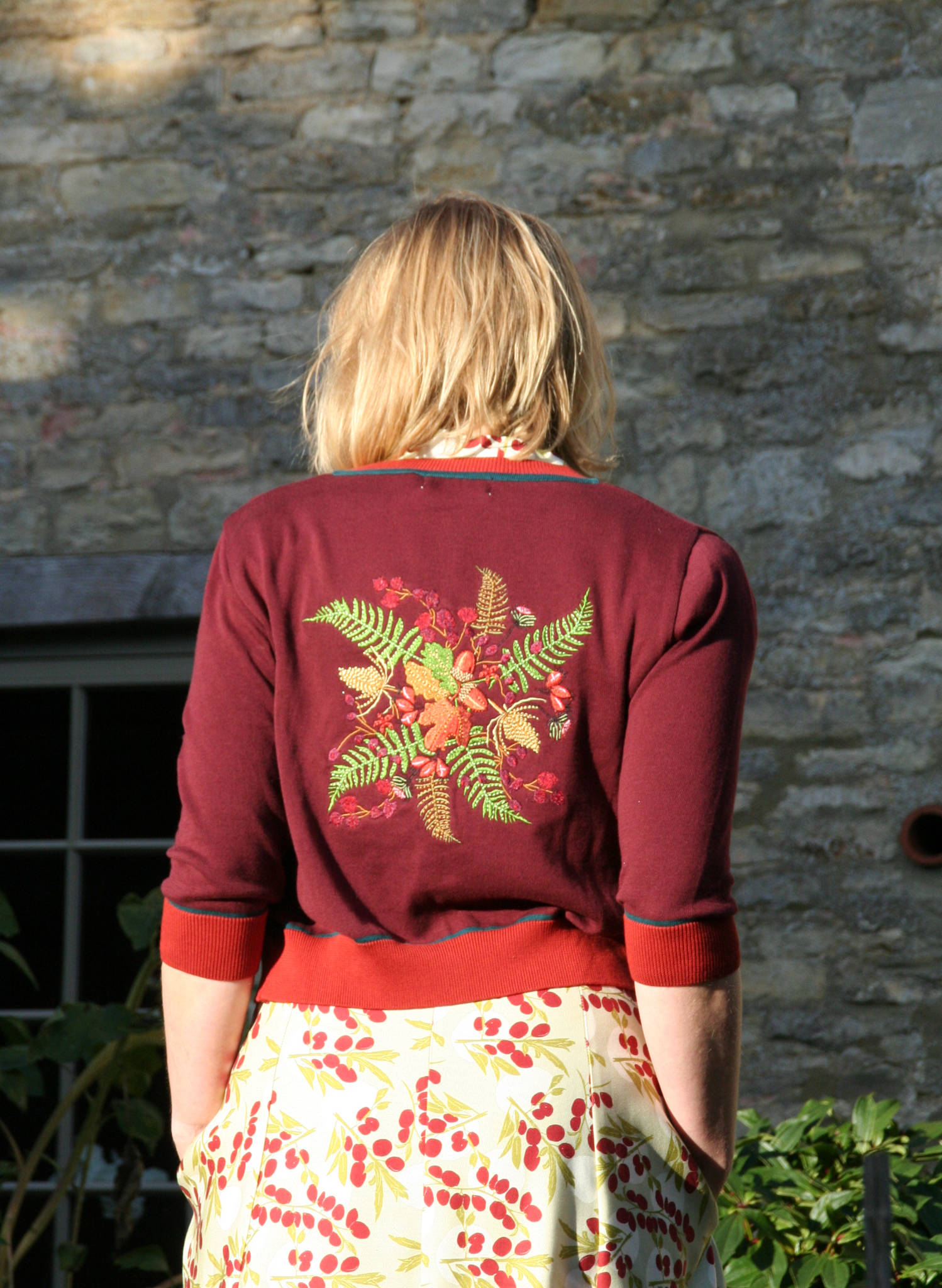 vintage style organic cotton knit cardigan in plum color with embroidered hedgerow in the back