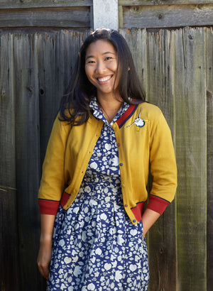 organic cotton knitted cardigan in mustard with red and navy trimmings and embroidered puffins