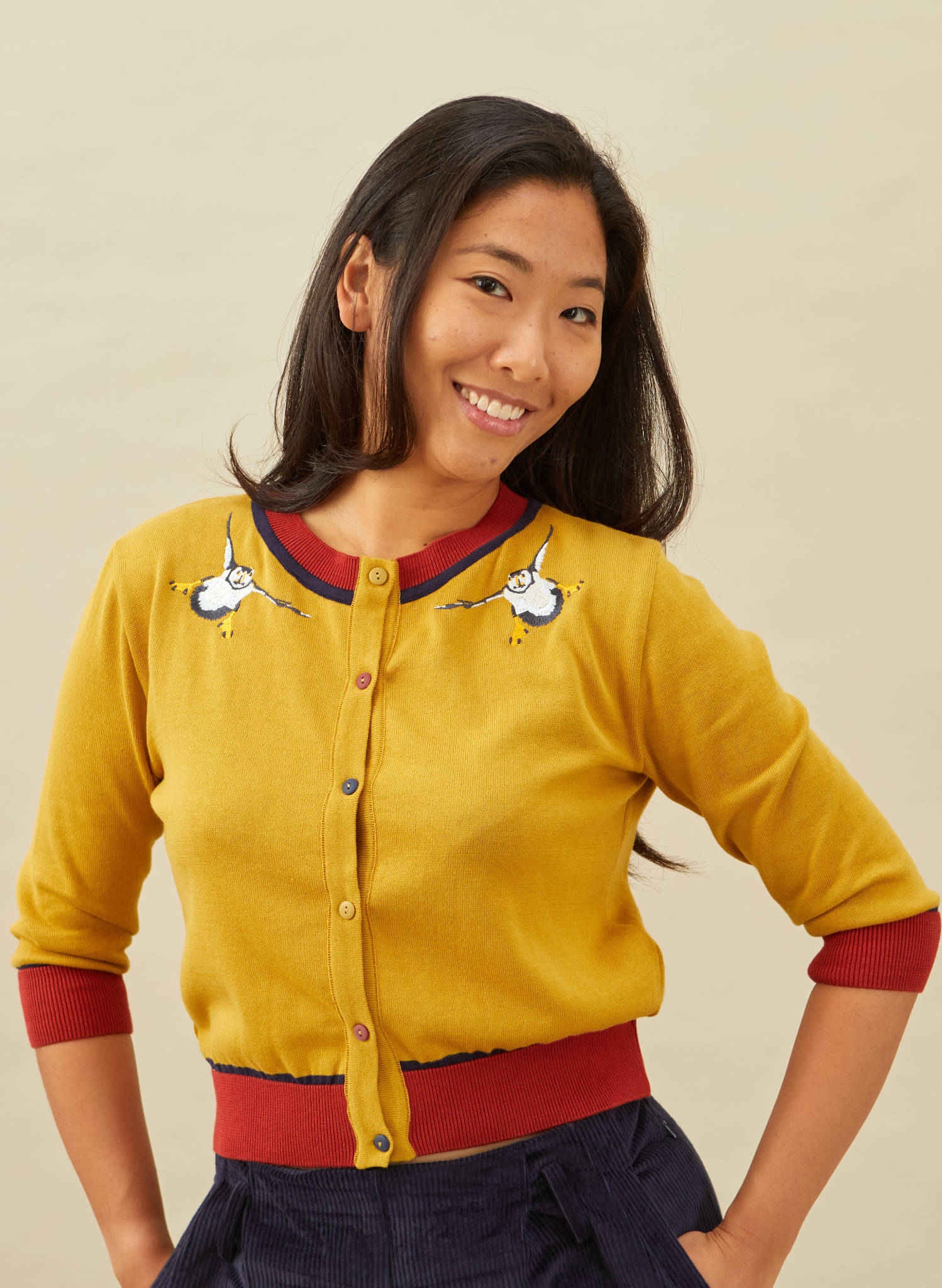 organic cotton knitted cardigan in mustard with red and navy trimmings and embroidered puffins